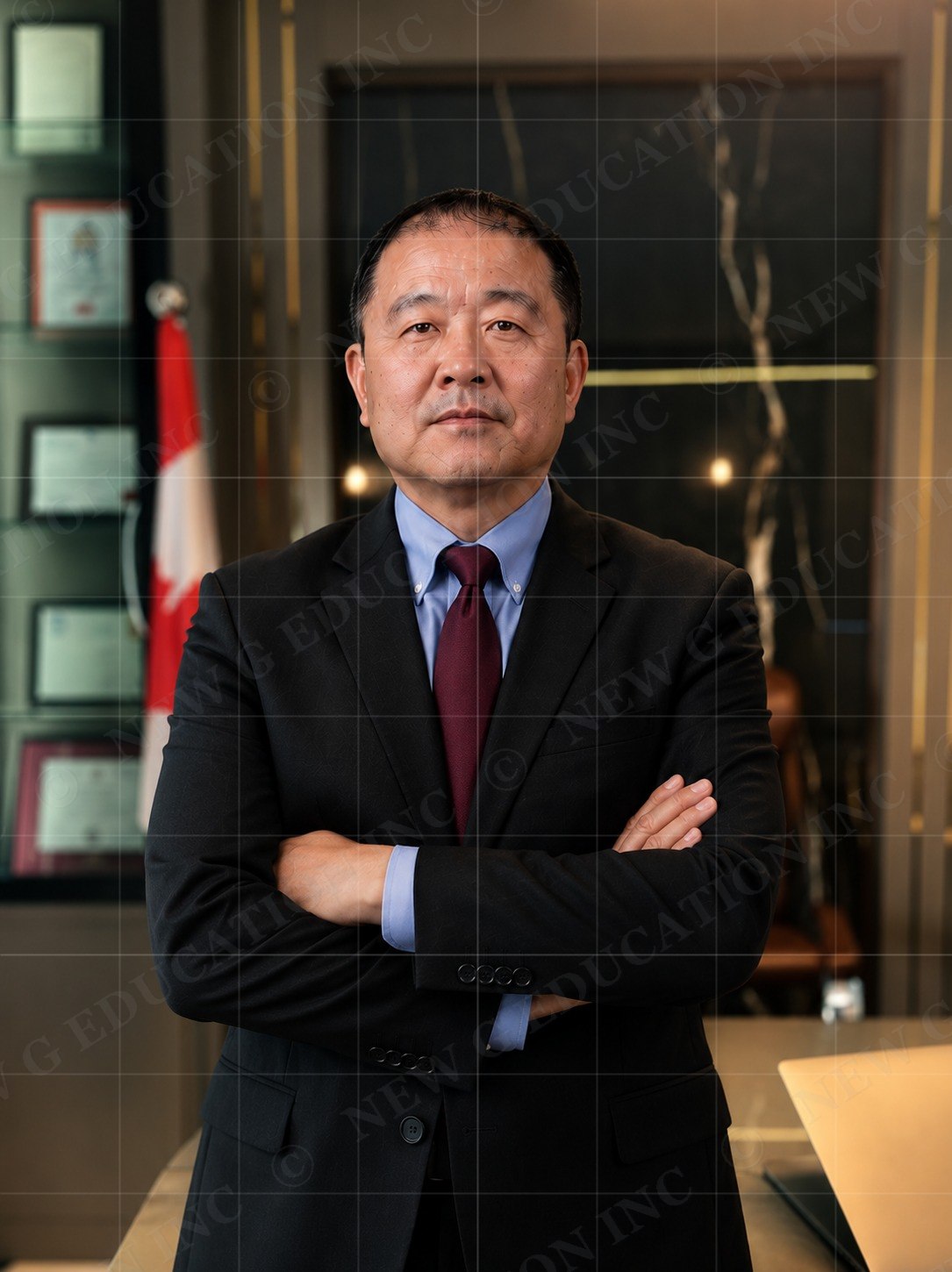 Xuan Zhang, Regulated Canadian Immigration Consultant, in his office beside the Canadian flag